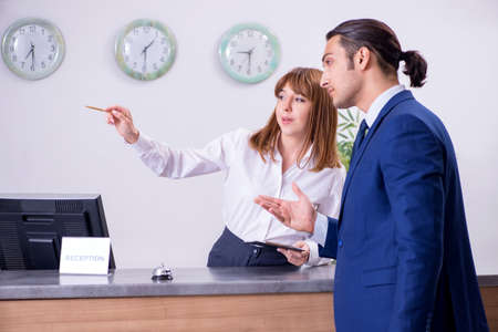 Young businessman at hotel receptionの写真素材