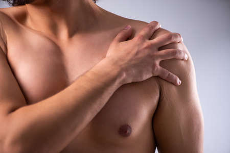 Young man suffering from upper limb painの写真素材