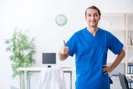 Young male doctor working in the clinicの写真素材