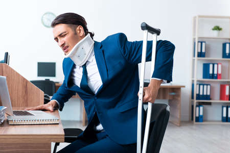 Young employee after accident in the officeの写真素材