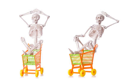 Skeleton with shopping cart trolley isolated on whiteの写真素材