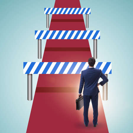 Businessman facing running barriers in challenging businessの写真素材