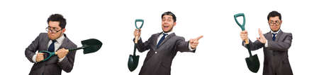 Young businessman holding a spade isolated on whiteの写真素材