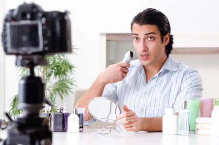 Young handsome man recording his blog in hygiene conceptの写真素材
