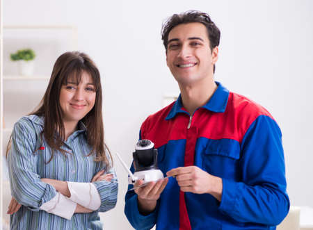 The client getting securty camera installed at home by contracto