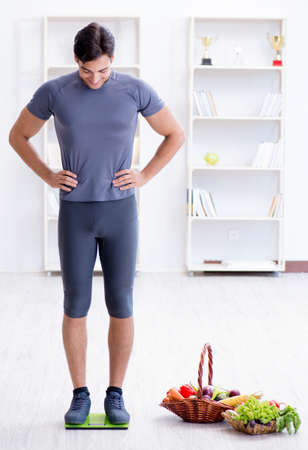 Man promoting the benefits of healthy eating and doing sportsの写真素材