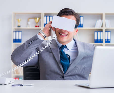 Businessman with virtual reality glasses in modern technology coの写真素材