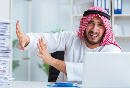 Arab businessman working in the office doing paperwork with a piの写真素材