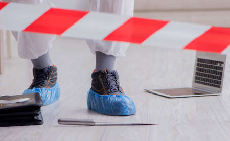 The forensic expert at crime scene doing investigationの写真素材