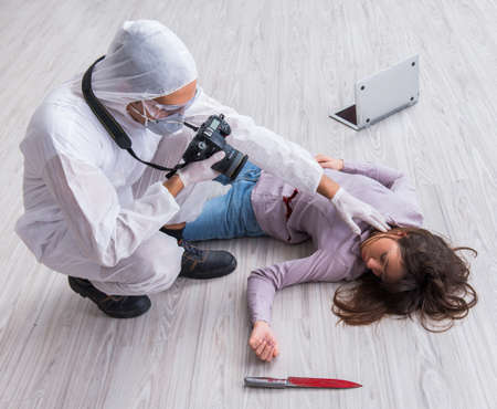 Forensic investigator at the crime scene investigating woman murの写真素材