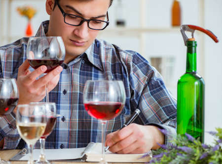 Professional sommelier tasting red wineの写真素材