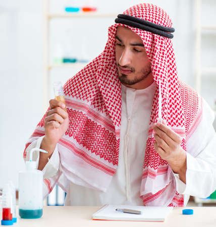 Arab chemist checking the quality of drinking waterの写真素材