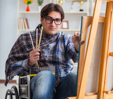 Disabled artist painting picture in studioの写真素材
