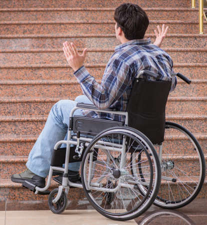 Disabled man on wheelchair having trouble with stairsの写真素材