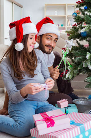 Young family expecting child baby celebrating christmasの写真素材
