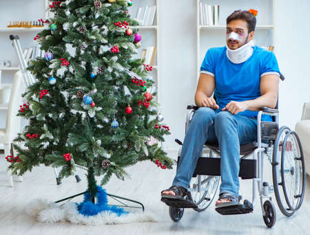 Injured disabled man celebrating christmas at homeの写真素材