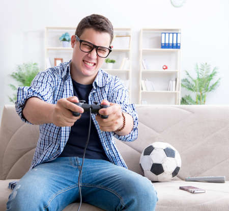 Young man playing computer games at home