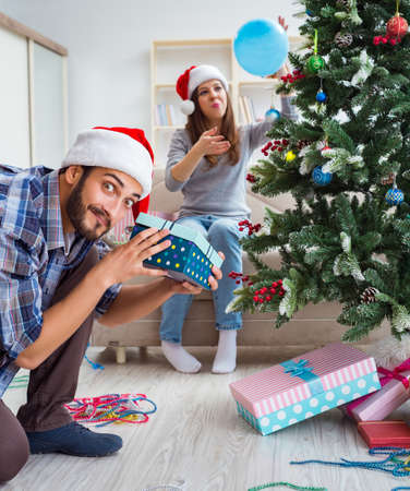 Girlfriend and boyfriend opening christmas giftsの写真素材
