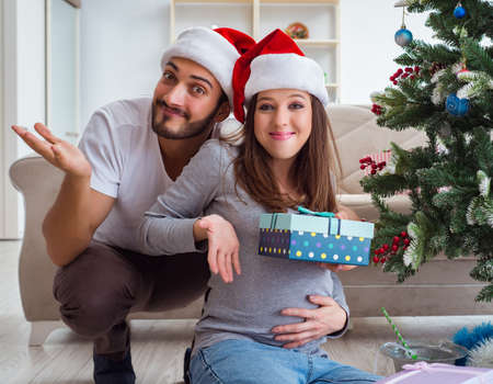Young family expecting child baby celebrating christmasの写真素材