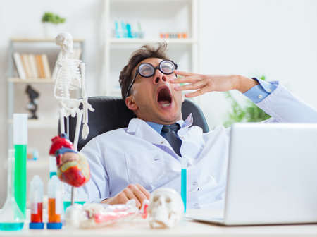 Funny doctor having fun in hospital labの写真素材