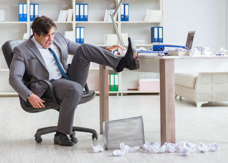 Angry businessman shocked working in the office fired sackedの写真素材