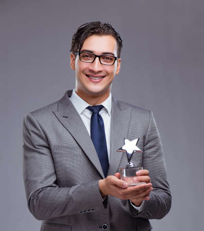 Businessman holding star award in business conceptの写真素材