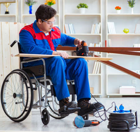 Disabled man working with circular sawの写真素材