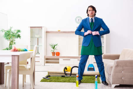 Young businessman cleaning the houseの写真素材