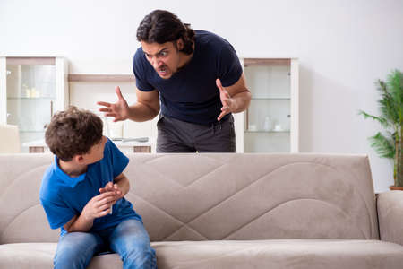 Concept of underage smoking with young boy and familyの写真素材