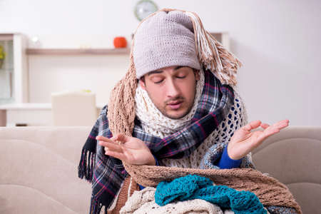 Young man suffering at homeの写真素材