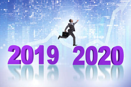 Businessman jumping from year 2019 to 2020