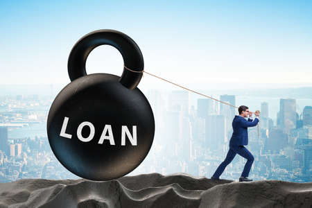 Debt and loan concept with businessman pulling kettlebellの写真素材
