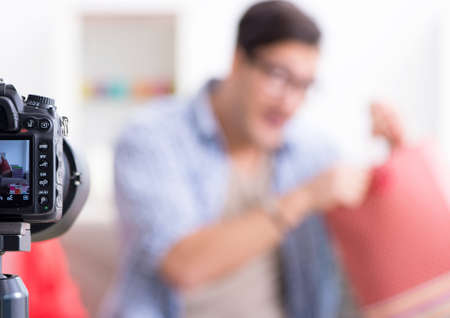 Male fashion blogger recording video for vlog