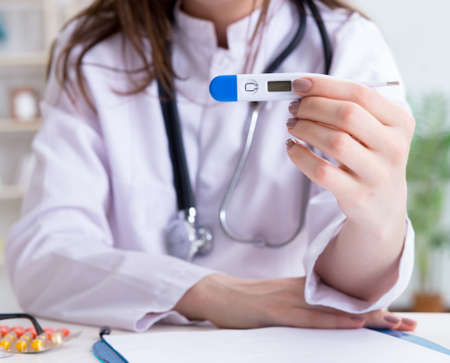 The doctor with thermometer in the hospitalの写真素材