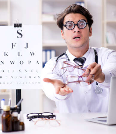 The funny eye doctor in humourous medical conceptの写真素材