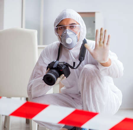 Forensic expert at crime scene doing investigationの写真素材