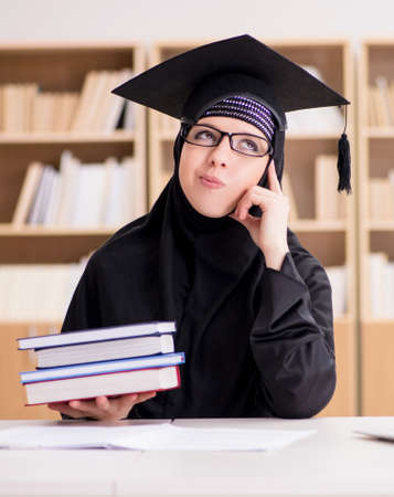 Muslim girl in hijab studying preparing for examsの写真素材