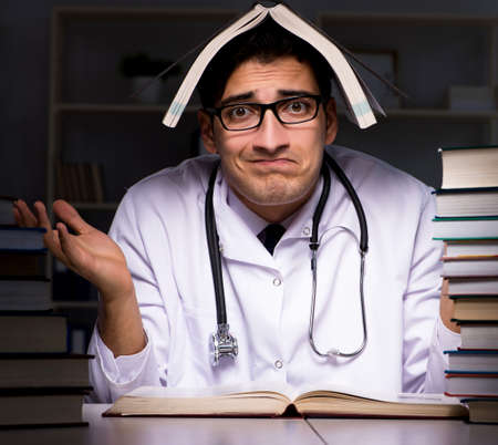 The medical student preparing for university exams at nightの写真素材