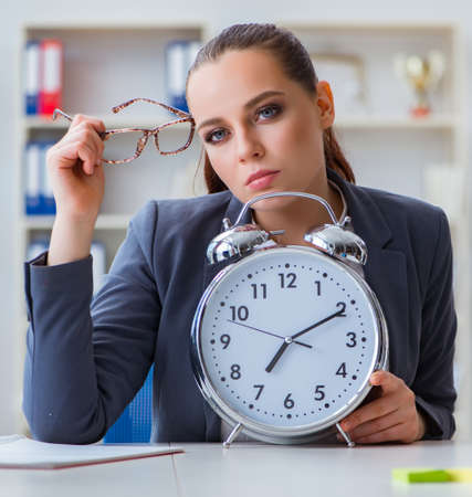 Businesswoman in time management conceptの写真素材