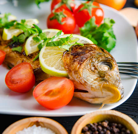 Fried fish served on the plateの写真素材