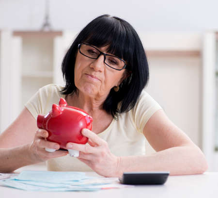 Mature woman trying to reconcile her bills