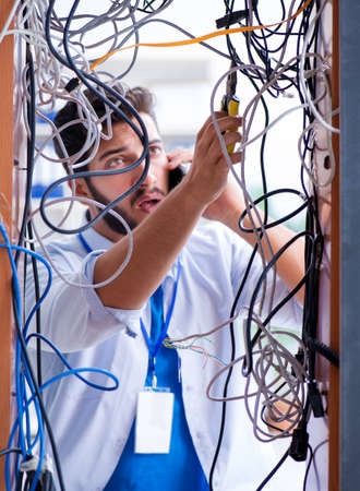 Electrician trying to untangle wires in repair concept