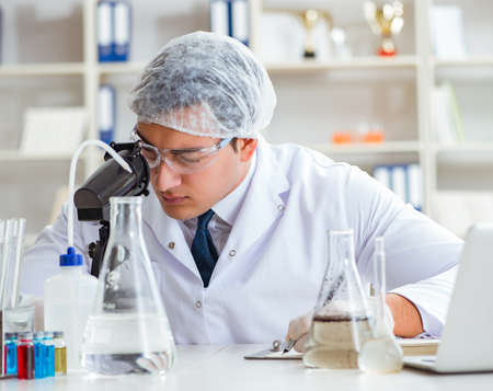 Young researcher scientist doing a water test contamination expeの写真素材