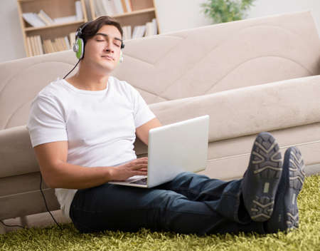 Freelancer working at home and listening to musicの写真素材