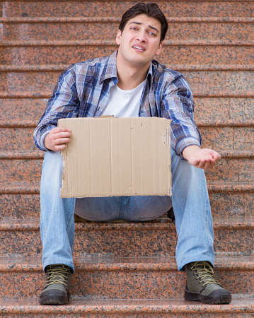 Young man begging money on the streetの写真素材