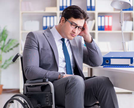 Disabled businessman working in the officeの写真素材