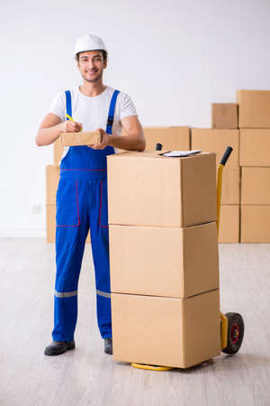 Young male professional mover doing home relocationの写真素材