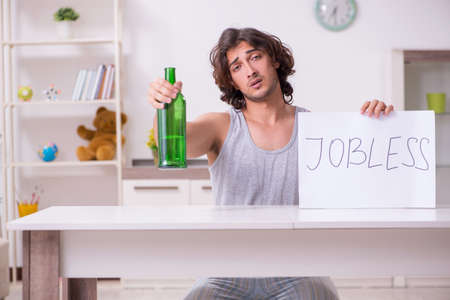 Unemployed man desperate at homeの写真素材