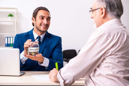 Financial advisor giving retirement advice to old manの写真素材