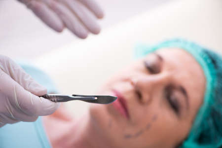 Old woman visiting male doctor for plastic surgery